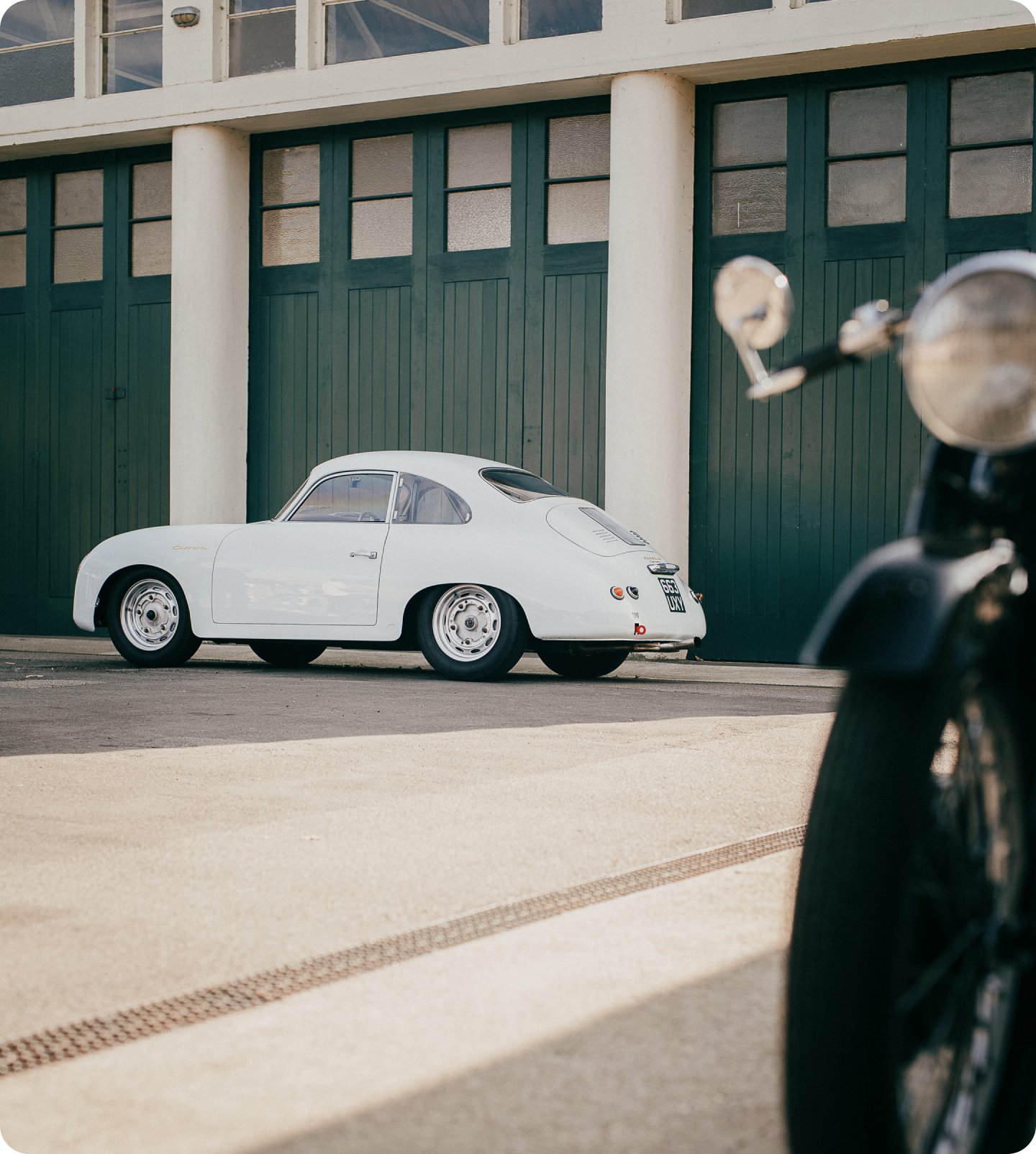 A close up of the front of a classic Yellow BMW, showing the badge in detail