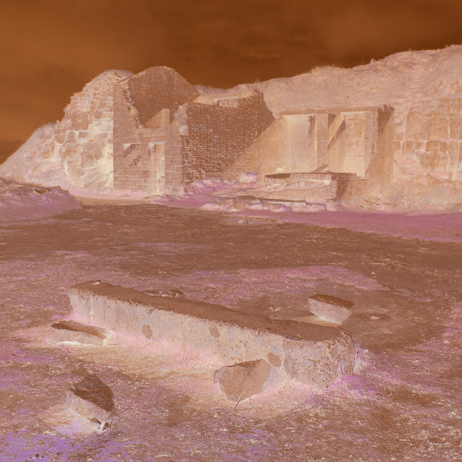 A negative photo of an abandoned mine building